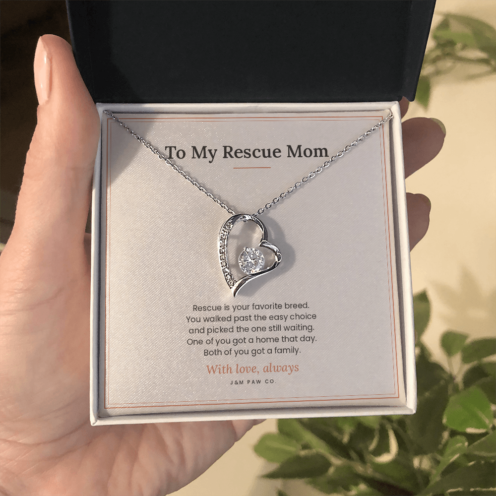 Rescue Mom Forever Love necklace held in hand showing heart pendant and message card
